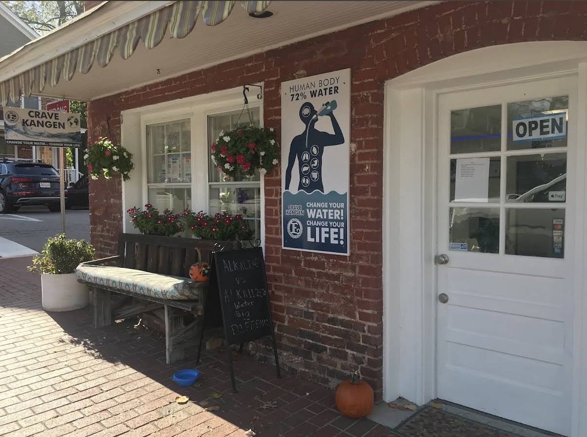 The Crave Kangen brick storefront on Union Street, with the Change Your Water sign, bench, and flowers